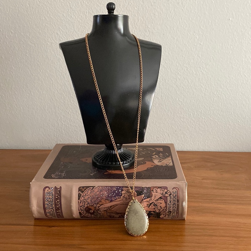 Long gold-tone necklace with gray teardrop stone bead pendant